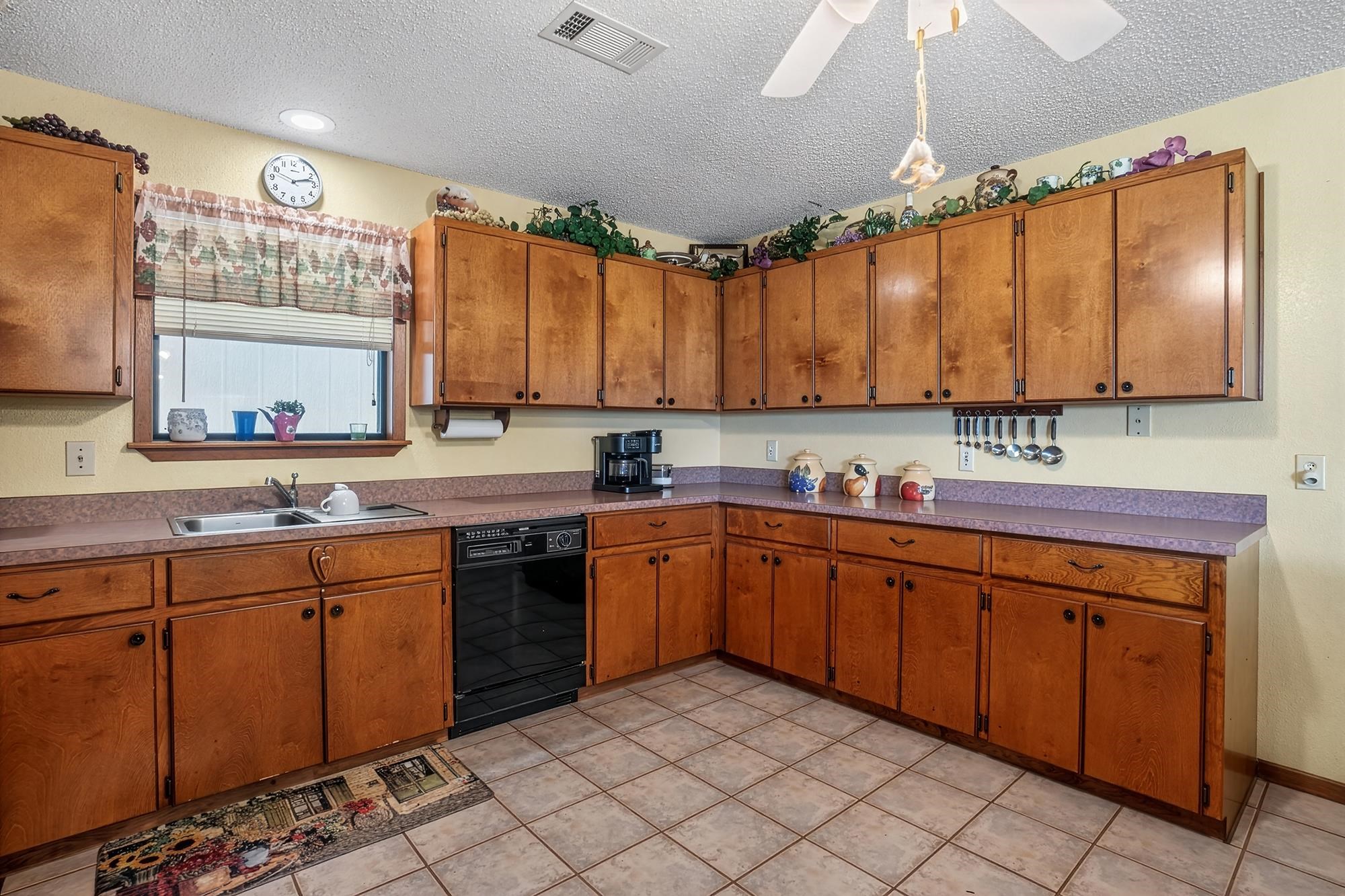 10465 Ranch To Market 1431 Buchanan Dam, TX 78609 - Photo 23 of 29 a kitchen with a sink cabinets and window