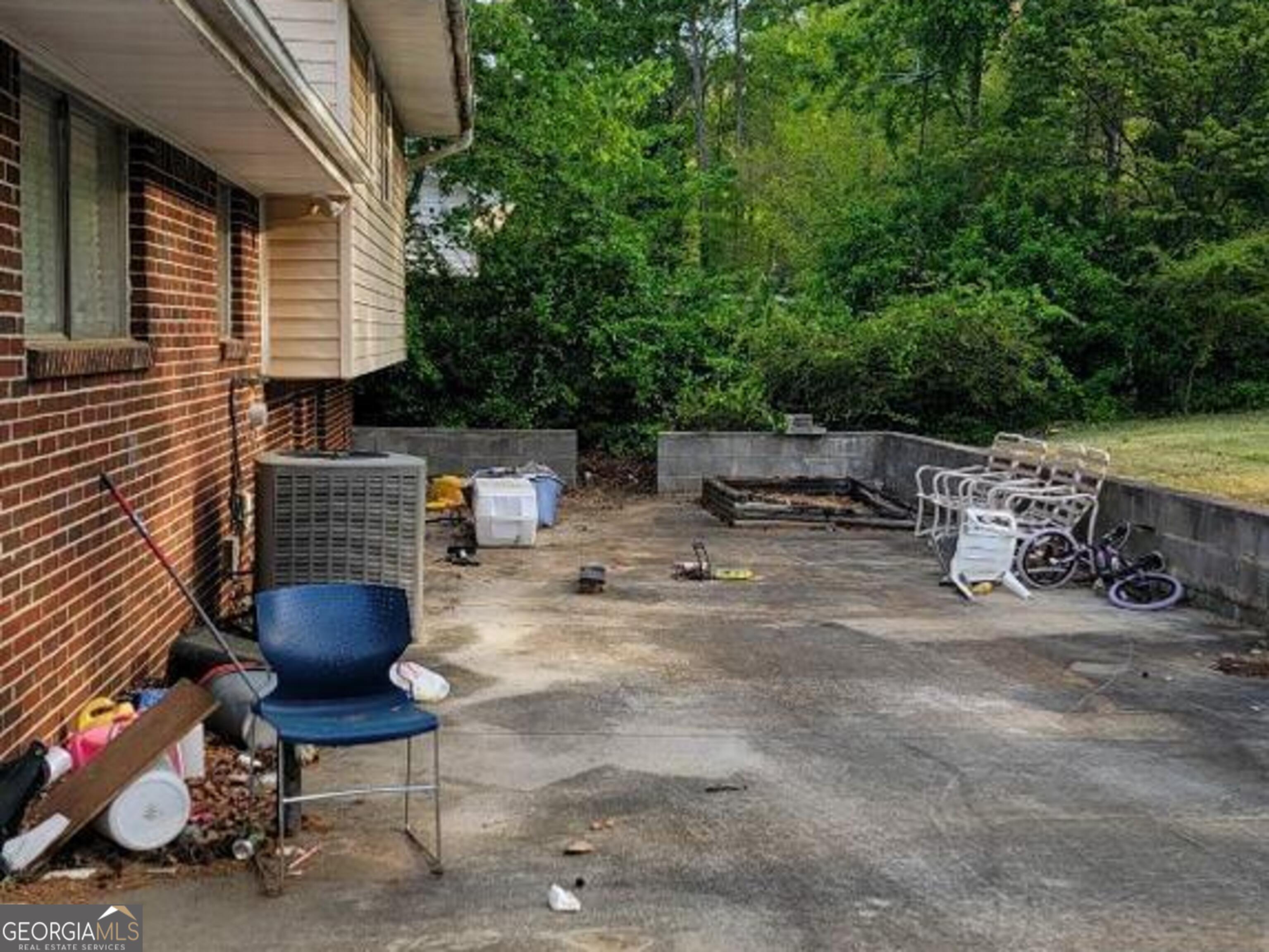 6052 Pinecreek Road Forest Park, GA 30297 - Photo 11 of 12 a view of backyard with table and chairs and a large tree