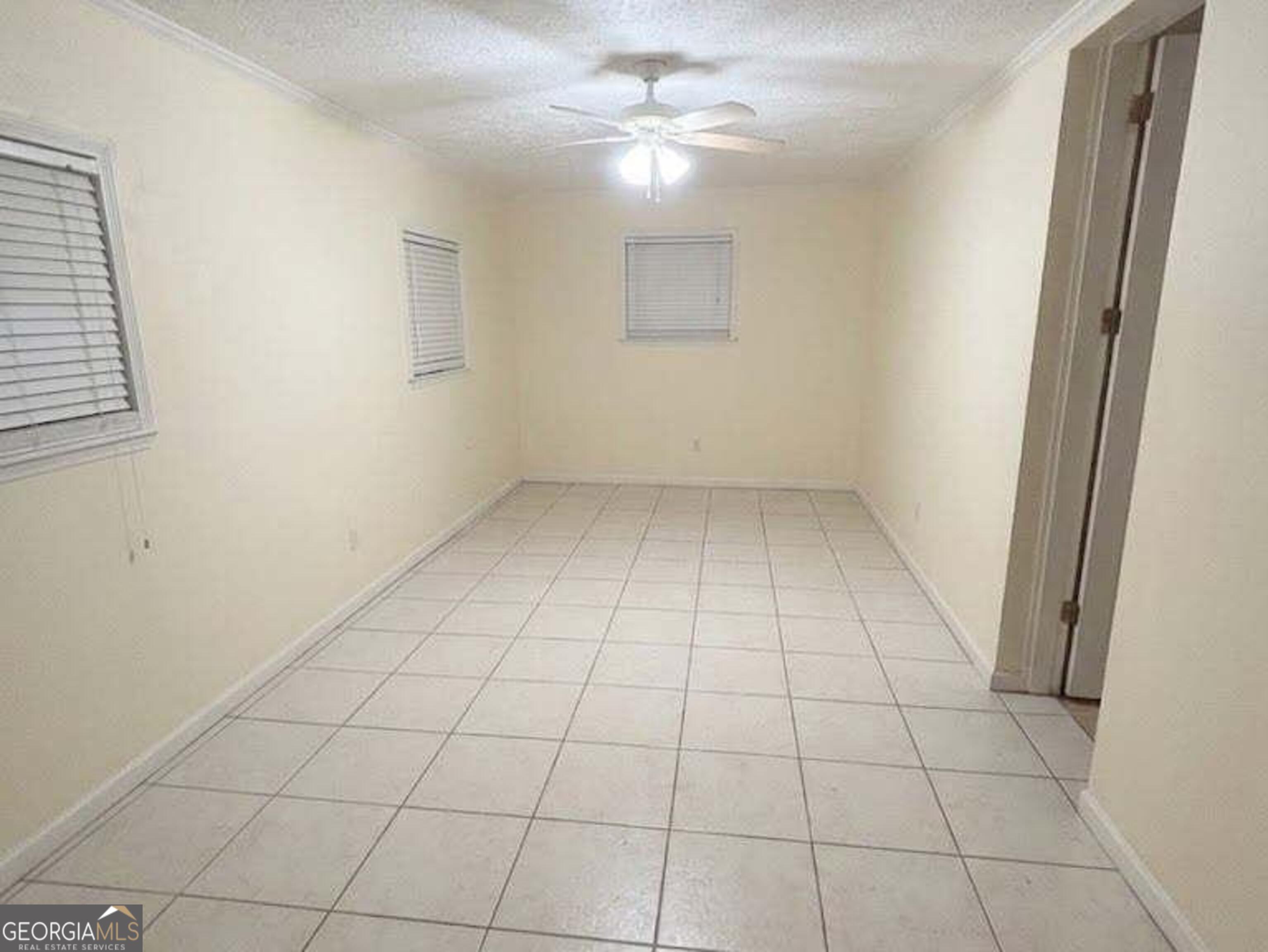 6052 Pinecreek Road Forest Park, GA 30297 - Photo 4 of 12 a view of an empty room with a window