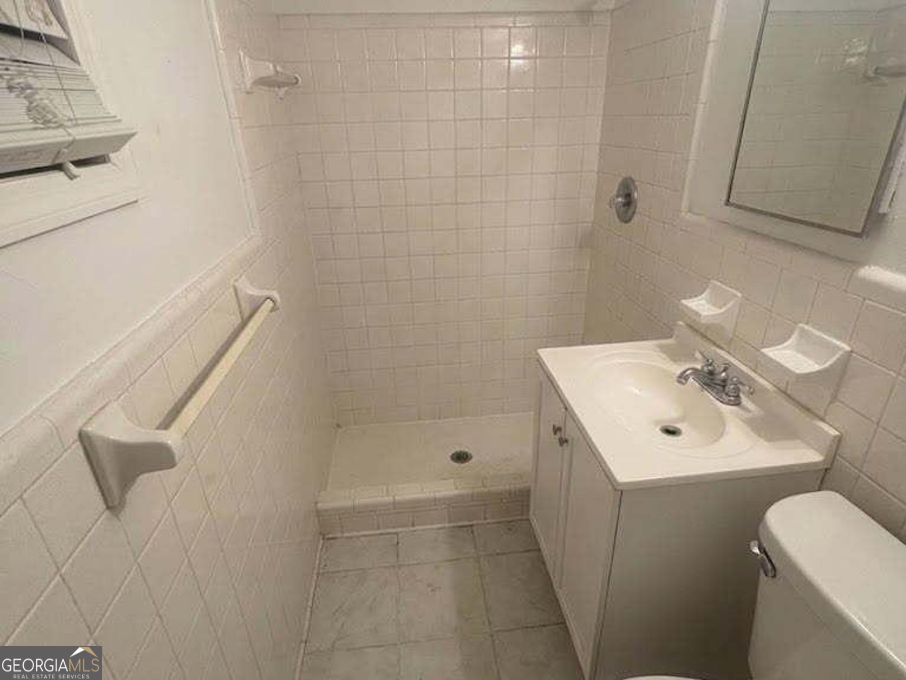 6052 Pinecreek Road Forest Park, GA 30297 - Photo 6 of 12 a bathroom with a sink a toilet and shower