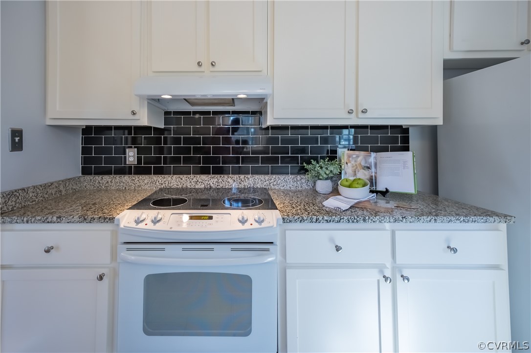5012 Rollingway Road Chesterfield, VA 23832 - Photo 21 of 35 a kitchen with granite countertop a sink a stove and cabinets