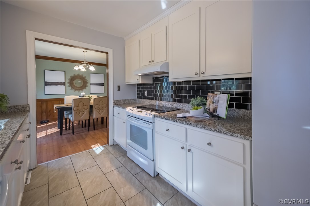 5012 Rollingway Road Chesterfield, VA 23832 - Photo 23 of 35 a kitchen with granite countertop a sink and cabinets