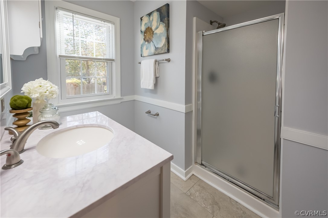 5012 Rollingway Road Chesterfield, VA 23832 - Photo 28 of 35 a bathroom with a granite countertop sink a window and shower
