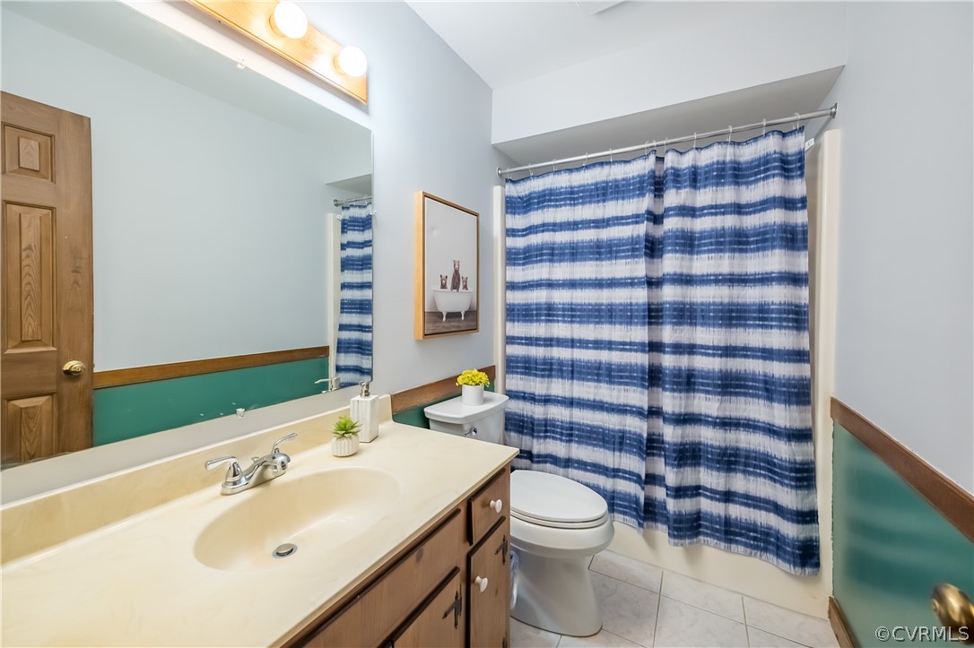 5012 Rollingway Road Chesterfield, VA 23832 - Photo 32 of 35 a bathroom with a sink a toilet and shower curtain