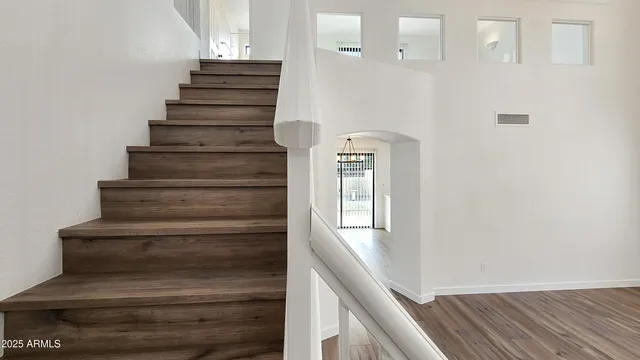 a view of entryway and hall with wooden floor