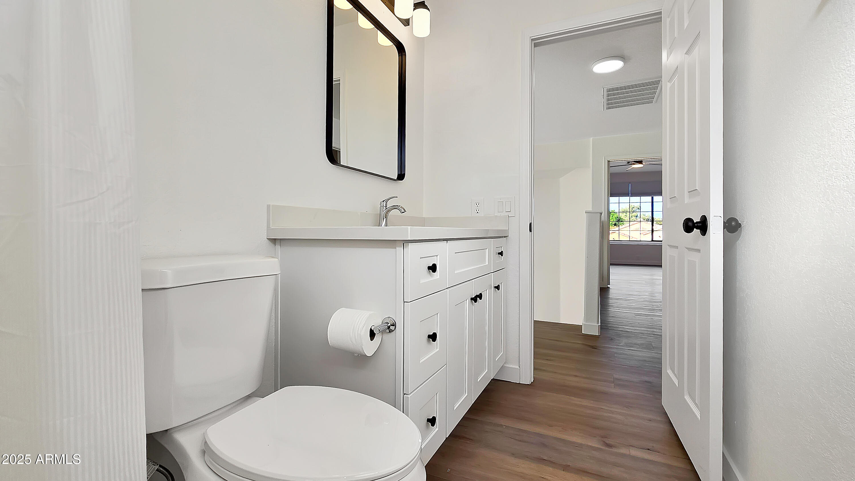 2119 West Tracy Lane Phoenix, AZ 85023 - Photo 25 of 31 a bathroom with a toilet sink and mirror