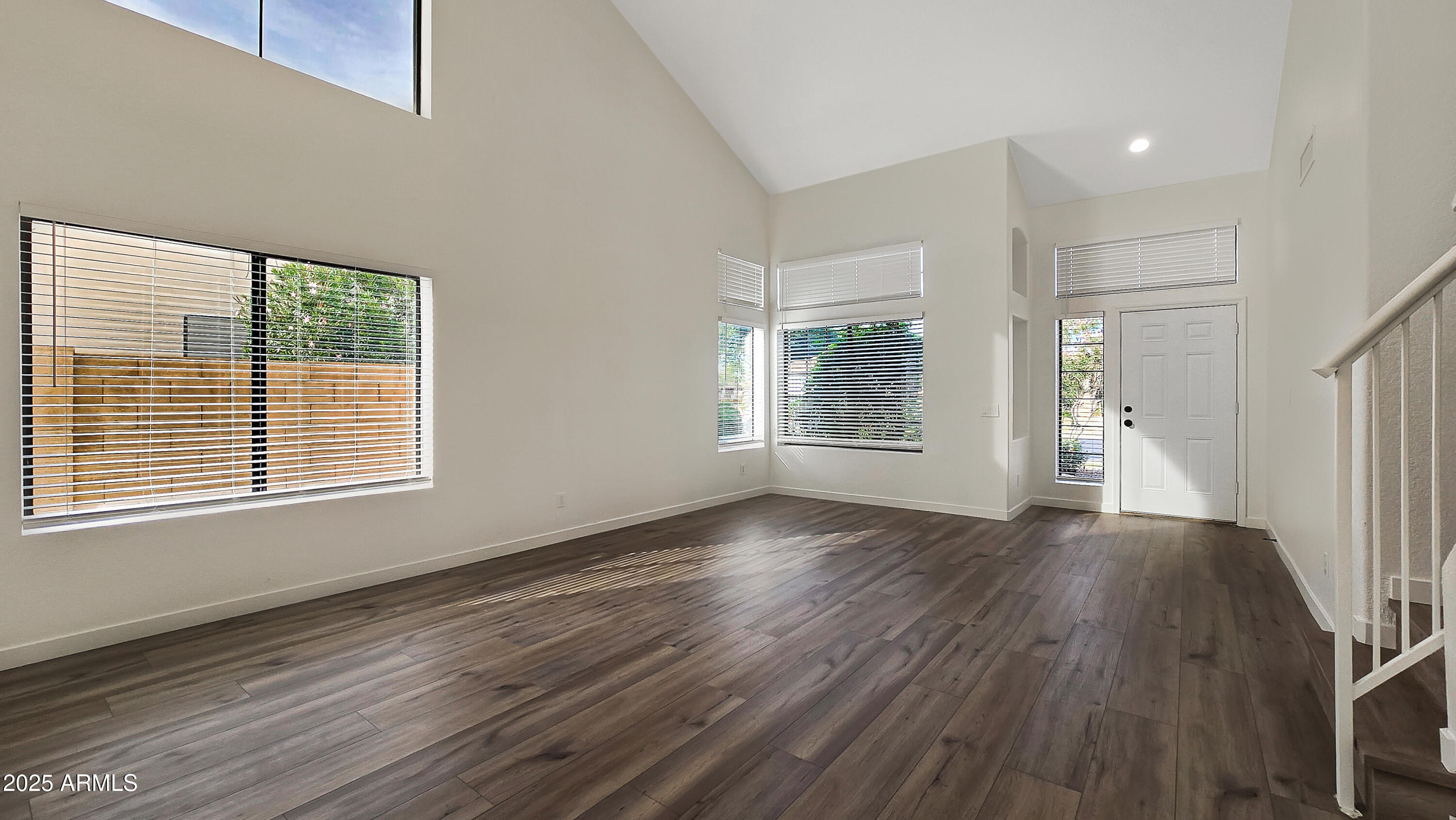 2119 West Tracy Lane Phoenix, AZ 85023 - Photo 3 of 31 a view of an empty room with wooden floor and a window