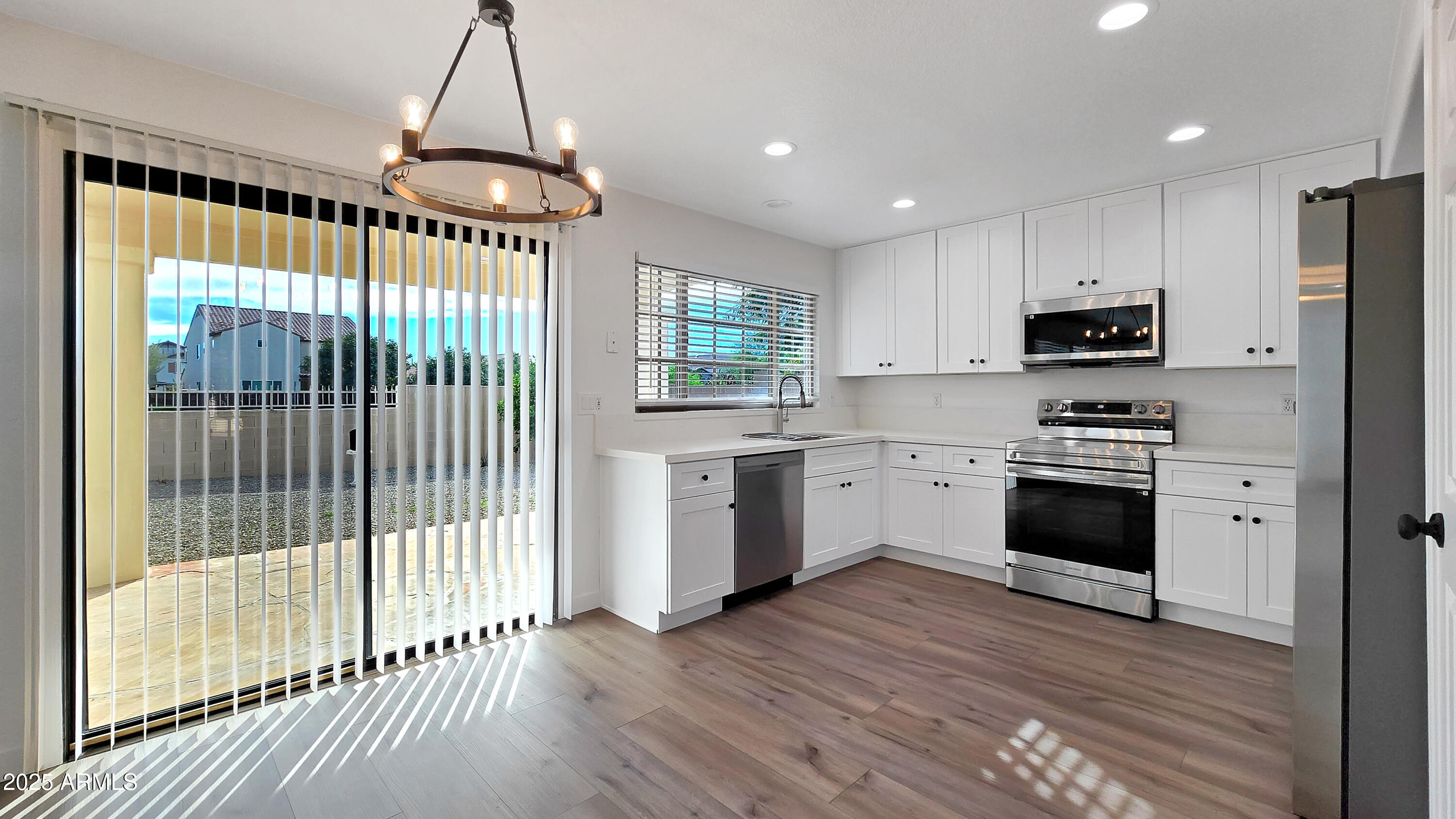 2119 West Tracy Lane Phoenix, AZ 85023 - Photo 6 of 31 a kitchen with granite countertop a stove a sink and a refrigerator