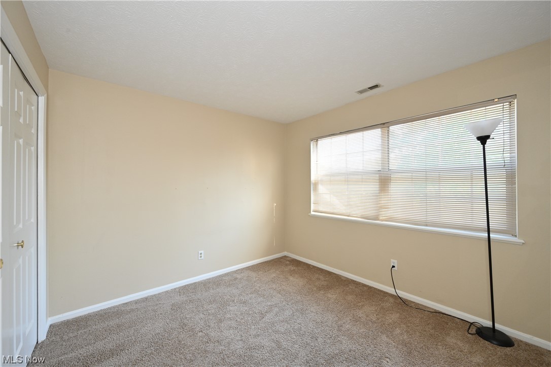 28140 Detroit Road, Unit A1 Westlake, OH 44145 - Photo 22 of 30 View of carpeted empty room