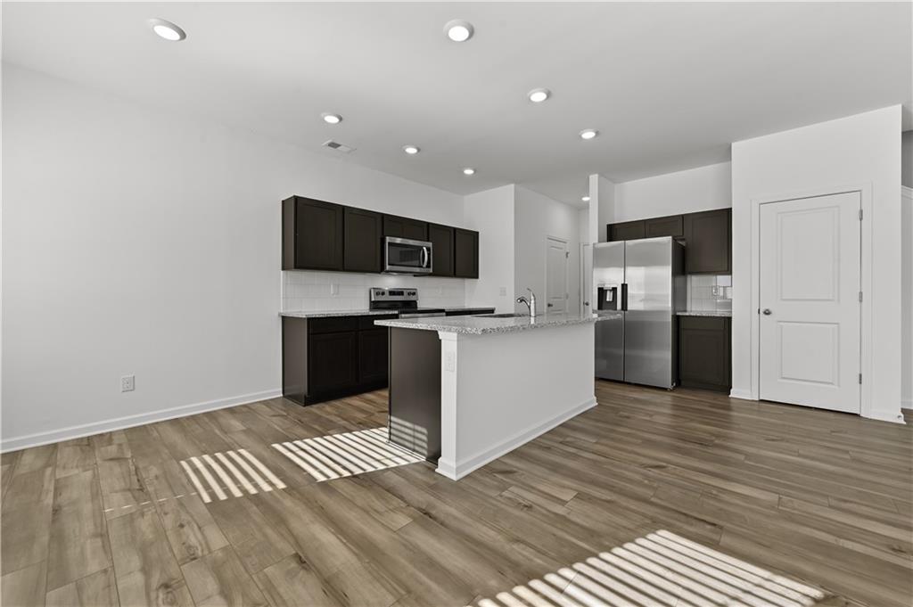 1102 Lossie Lane Grayson, GA 30017 - Photo 12 of 34 a view of kitchen with cabinets microwave and refrigerator