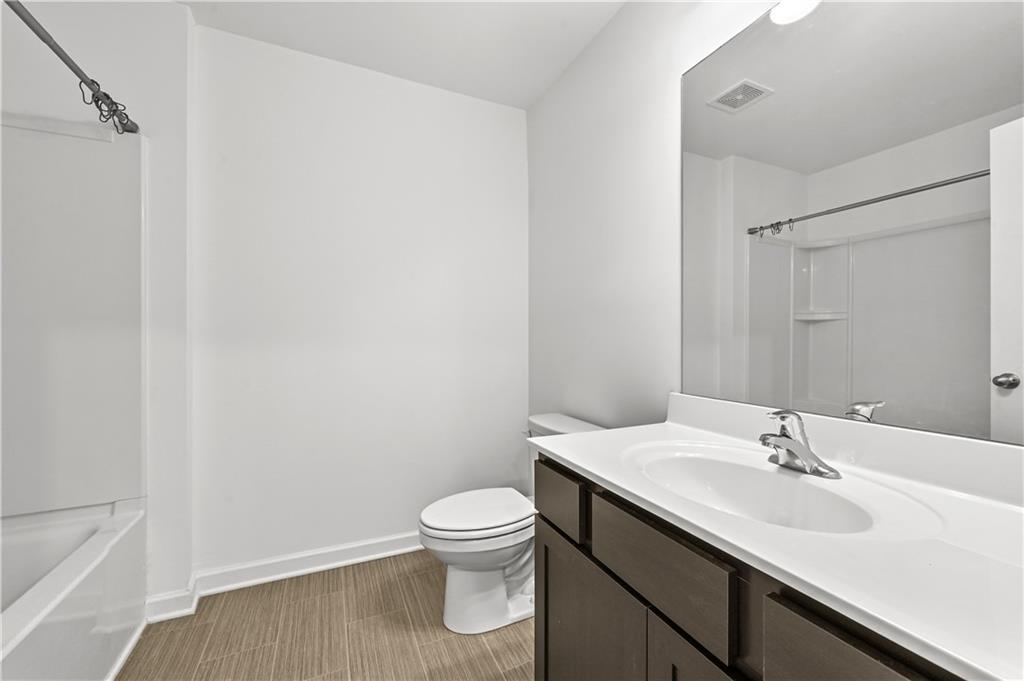 1102 Lossie Lane Grayson, GA 30017 - Photo 23 of 34 a bathroom with a sink toilet and vanity