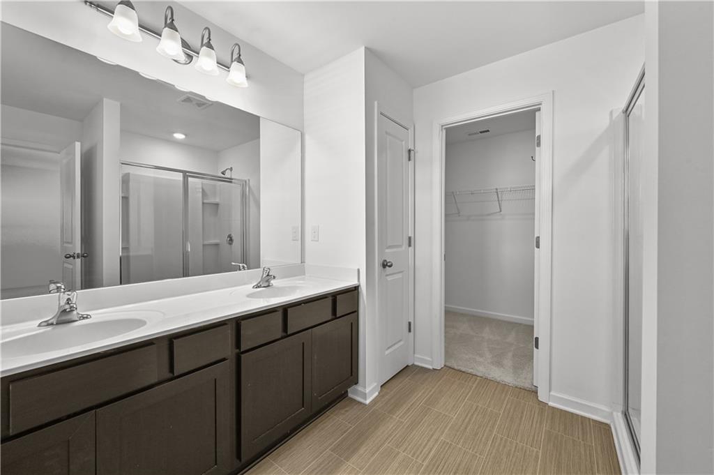 1102 Lossie Lane Grayson, GA 30017 - Photo 26 of 34 a bathroom with a double vanity sink and mirror