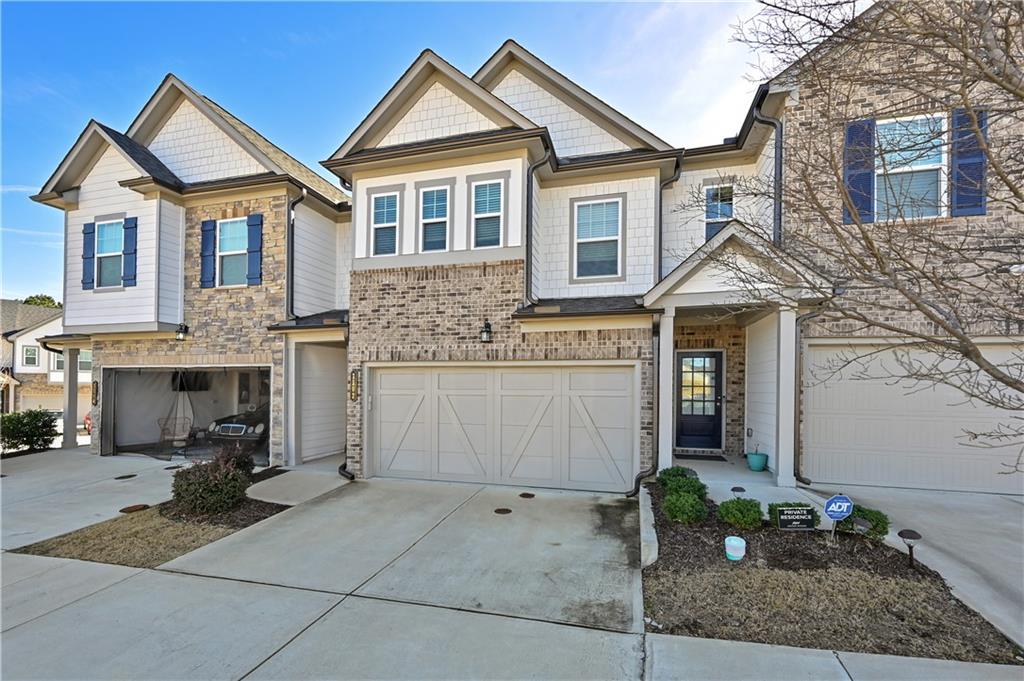 1102 Lossie Lane Grayson, GA 30017 - Photo 3 of 34 a front view of a house with a yard and garage