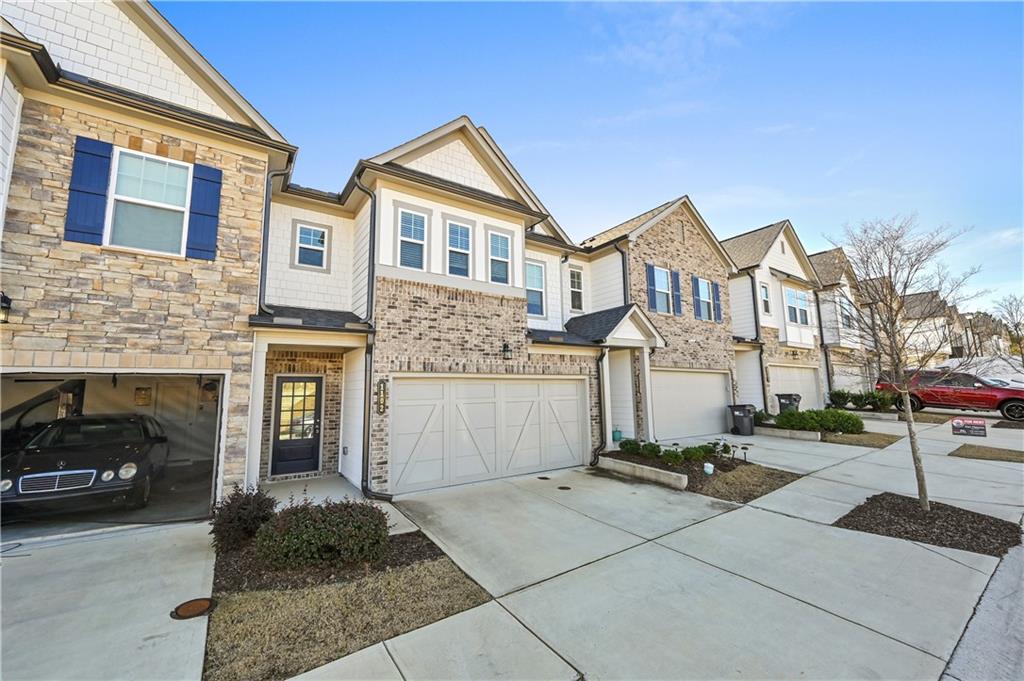 1102 Lossie Lane Grayson, GA 30017 - Photo 4 of 34 a front view of a house with a garden