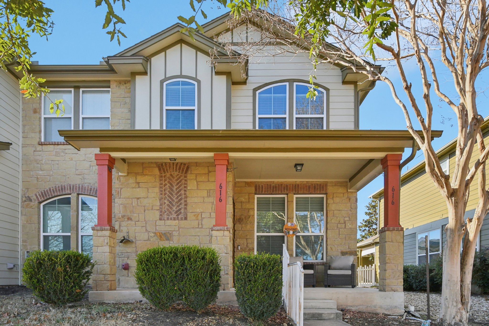 View of front of house with a porch and stone siding