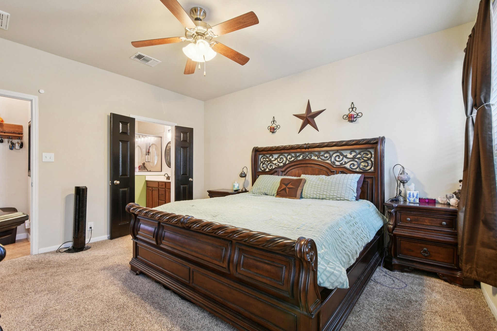 616 Lookout Tree Lane Round Rock, TX 78664 - Photo 11 of 39 Bedroom with connected bathroom, light carpet, and ceiling fan