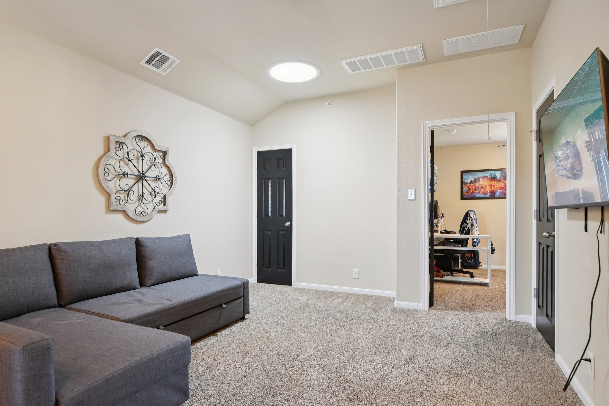 616 Lookout Tree Lane Round Rock, TX 78664 - Photo 18 of 39 Living area featuring lofted ceiling and light colored carpet