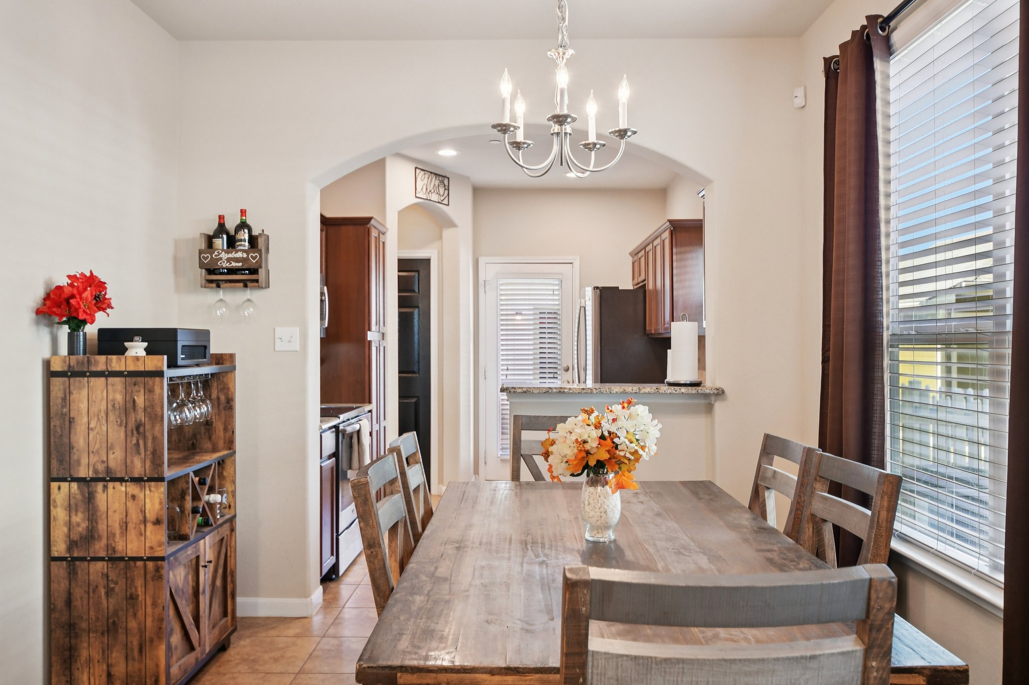 616 Lookout Tree Lane Round Rock, TX 78664 - Photo 7 of 39 Dining room featuring suspended lighting, light tile patterned floors, and arched walkways