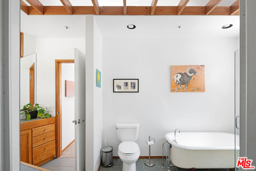 25830 Piuma Road Calabasas, CA 91302 - Photo 20 of 34 a white toilet sitting next to a bathroom sink and vanity