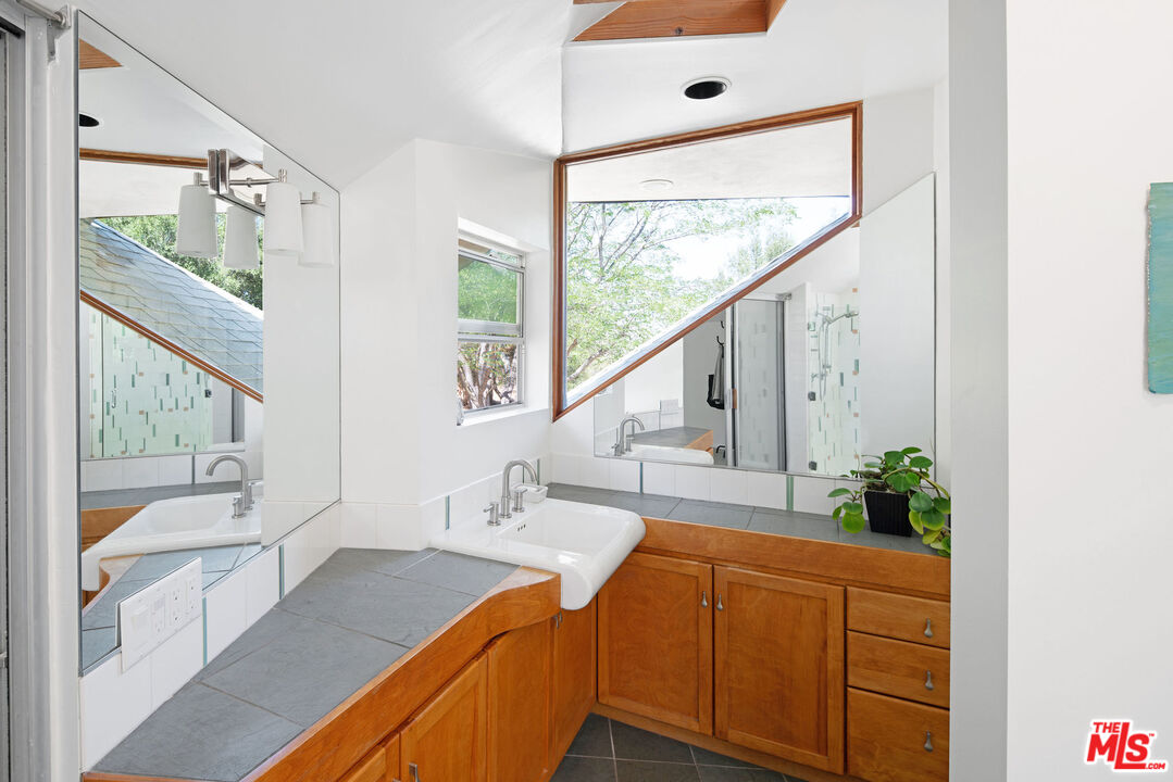 25830 Piuma Road Calabasas, CA 91302 - Photo 21 of 34 a kitchen with stainless steel appliances granite countertop a sink and a large window