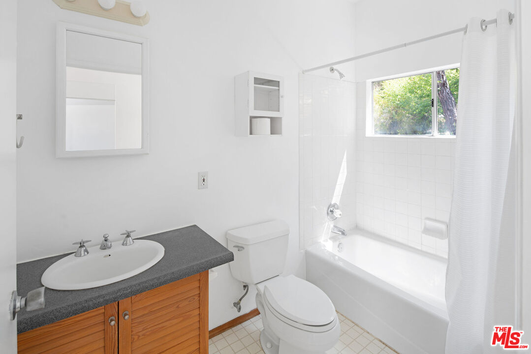 25830 Piuma Road Calabasas, CA 91302 - Photo 29 of 34 a bathroom with a granite countertop sink toilet a mirror and bathtub