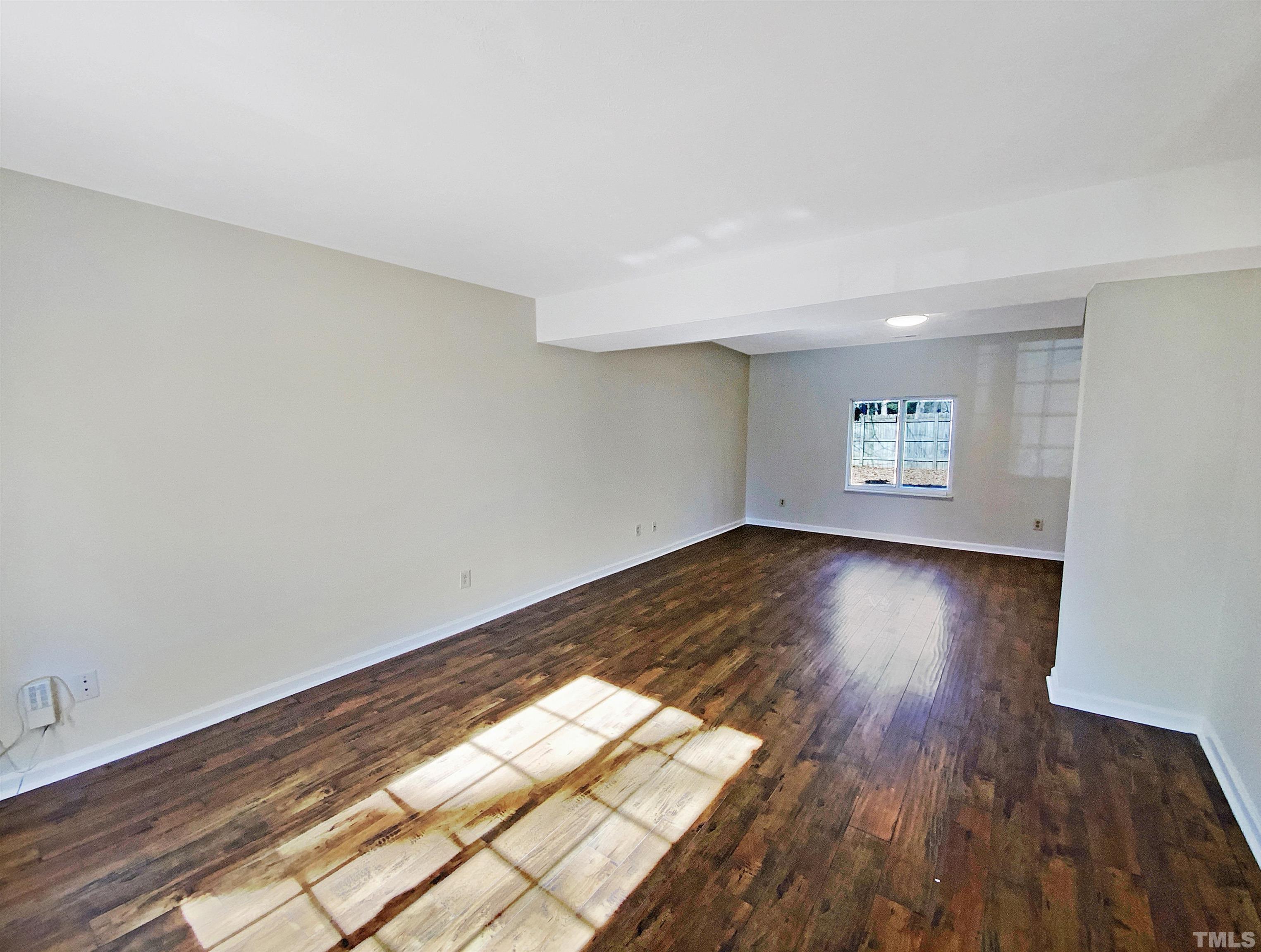 2508 Torbay Court Raleigh, NC 27613 - Photo 8 of 18 an empty room with wooden floor and windows