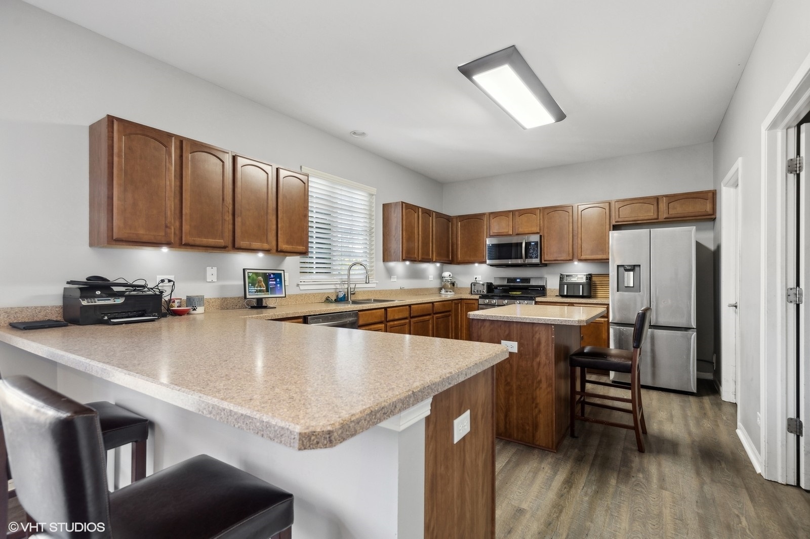 9740 Newton Road Huntley, IL 60142 - Photo 12 of 20 a kitchen with stainless steel appliances a sink a stove a refrigerator cabinets and a counter top space