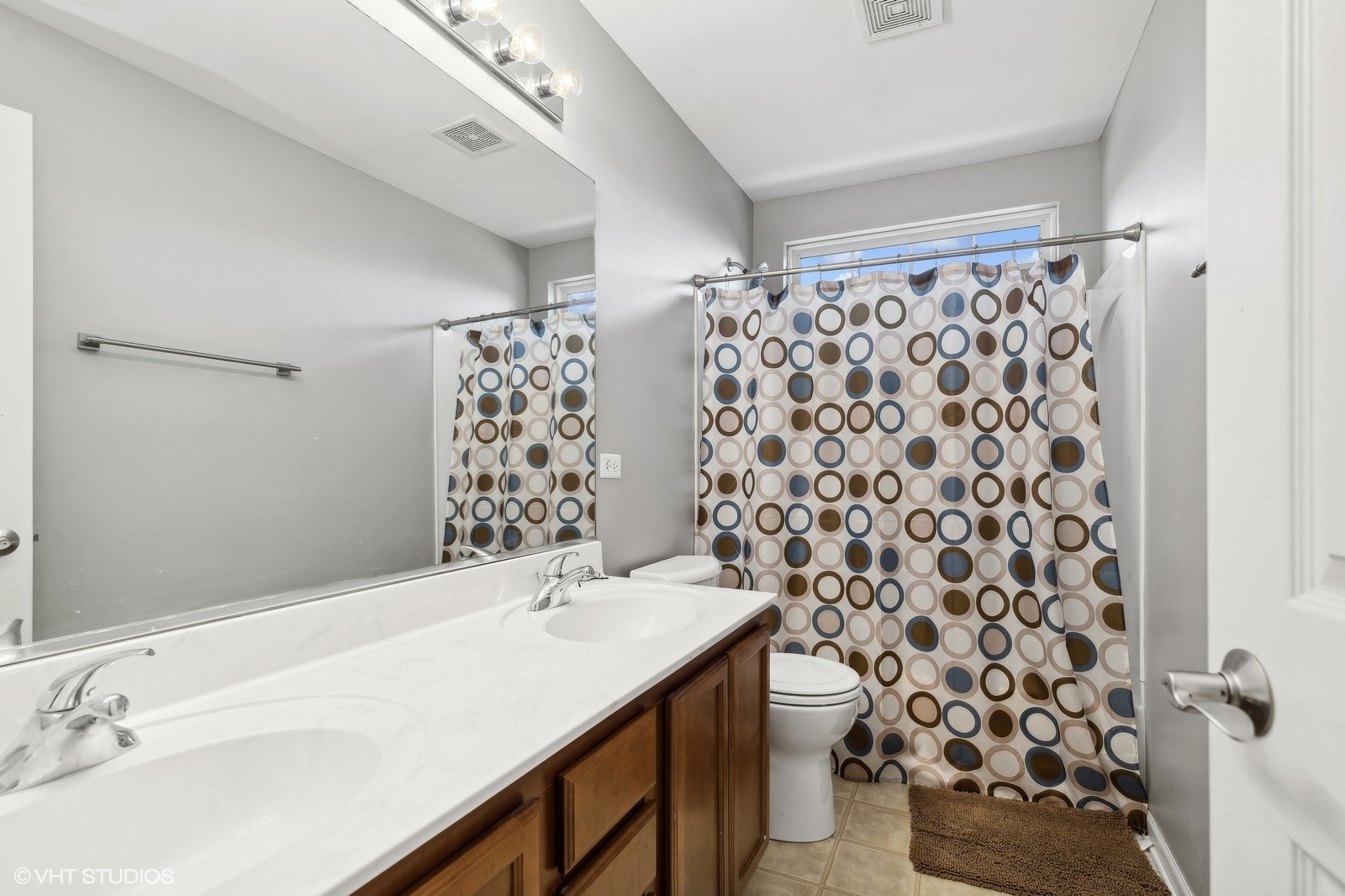 9740 Newton Road Huntley, IL 60142 - Photo 17 of 20 a bathroom with a sink toilet and shower
