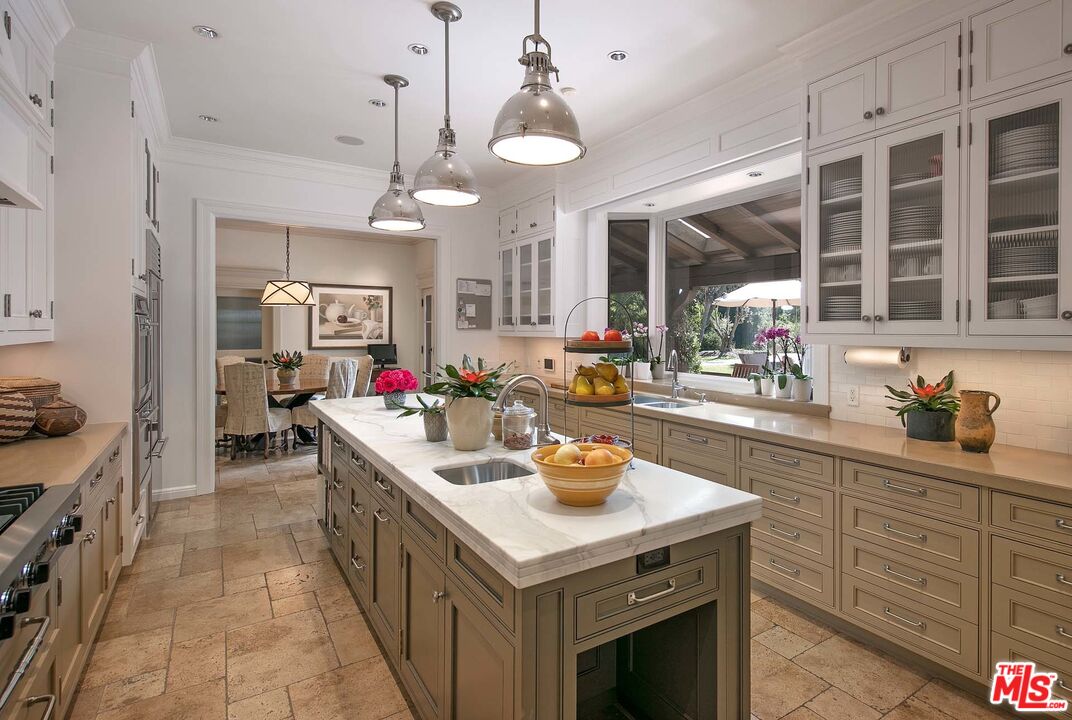 531 Barnaby Road Los Angeles, CA 90077 - Photo 11 of 28 a kitchen with a sink stove and cabinets
