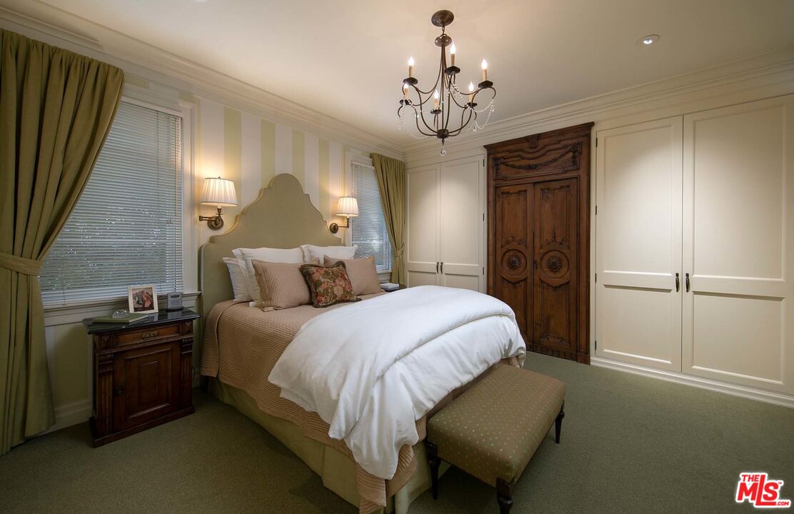 531 Barnaby Road Los Angeles, CA 90077 - Photo 18 of 28 a spacious bedroom with a bed and a chandelier