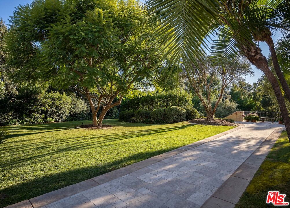 531 Barnaby Road Los Angeles, CA 90077 - Photo 23 of 28 a view of a swimming pool with a yard and large trees