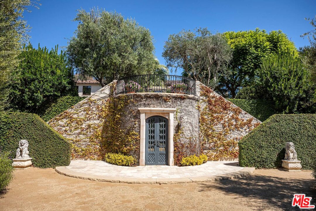 531 Barnaby Road Los Angeles, CA 90077 - Photo 26 of 28 a front view of a house with a yard
