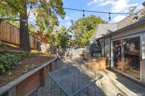 a view of a house with backyard sitting area and tub