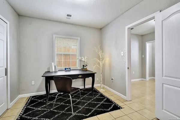 a view of a workspace room with wooden floor