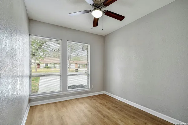 wooden floor in an empty room with a window