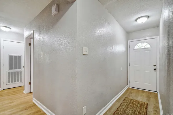 a view of hallway with wooden floor