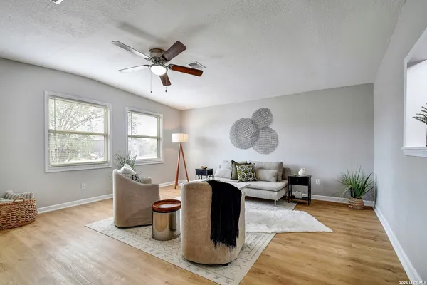 a living room with furniture window and wooden floor