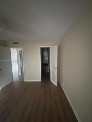 a view of hallway with wooden floor