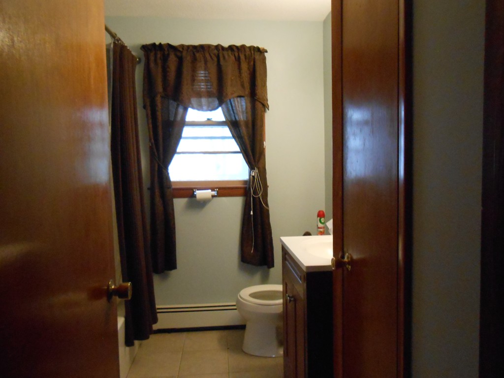 16 Varney Street Springfield, MA 01108 - Photo 3 of 6 a bathroom with a toilet and a shower curtain