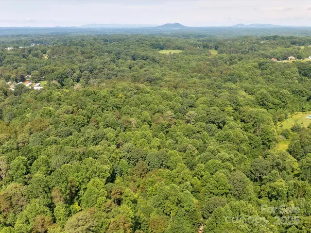a view of a green field with an ocean view