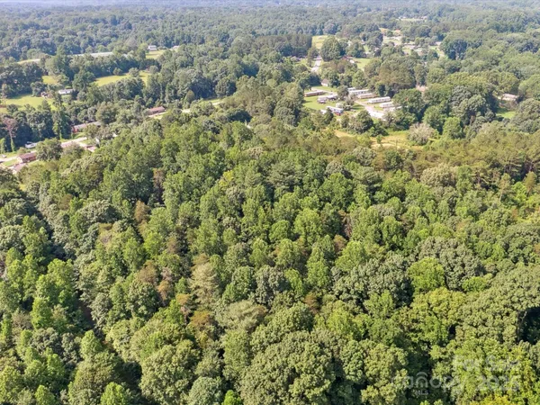 an aerial view of a houses with a yard