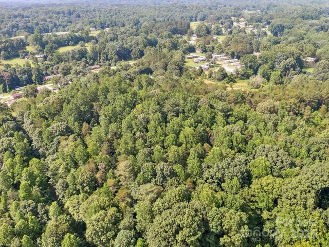 an aerial view of a houses with a yard