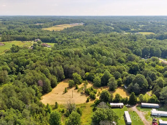 an aerial view of a houses with a yard