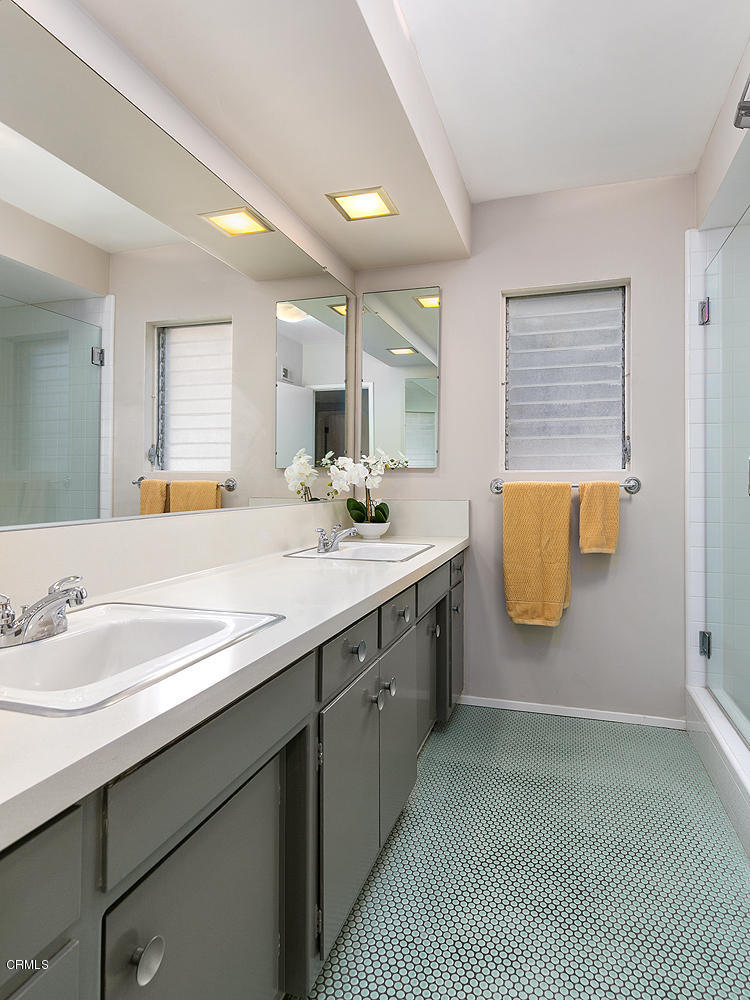 2044 Cricklewood Path Pasadena, CA 91107 - Photo 17 of 32 a bathroom with a double vanity sink a mirror and a bathtub