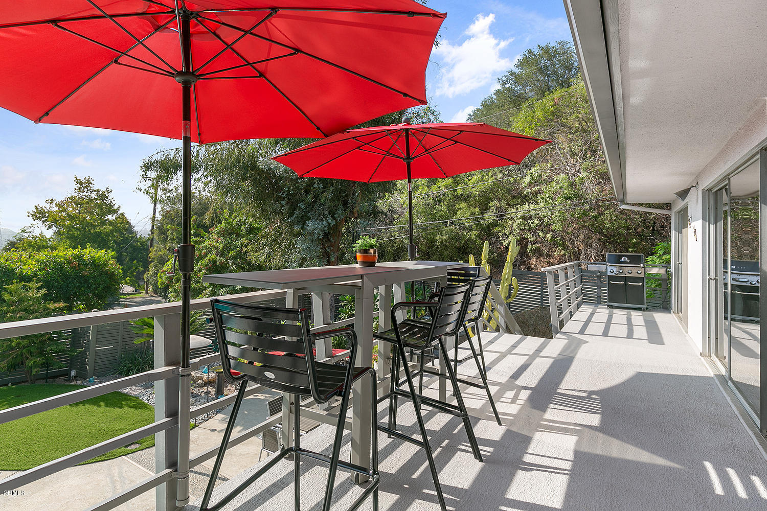 2044 Cricklewood Path Pasadena, CA 91107 - Photo 23 of 32 a view of a patio with a table and chairs under an umbrella