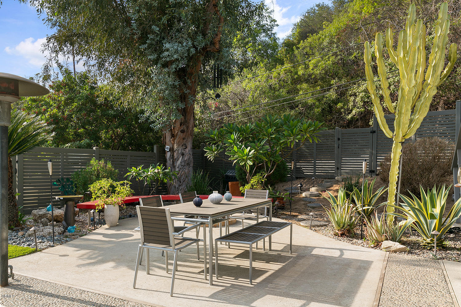 2044 Cricklewood Path Pasadena, CA 91107 - Photo 24 of 32 a view of a patio with table and chairs potted plants and large tree