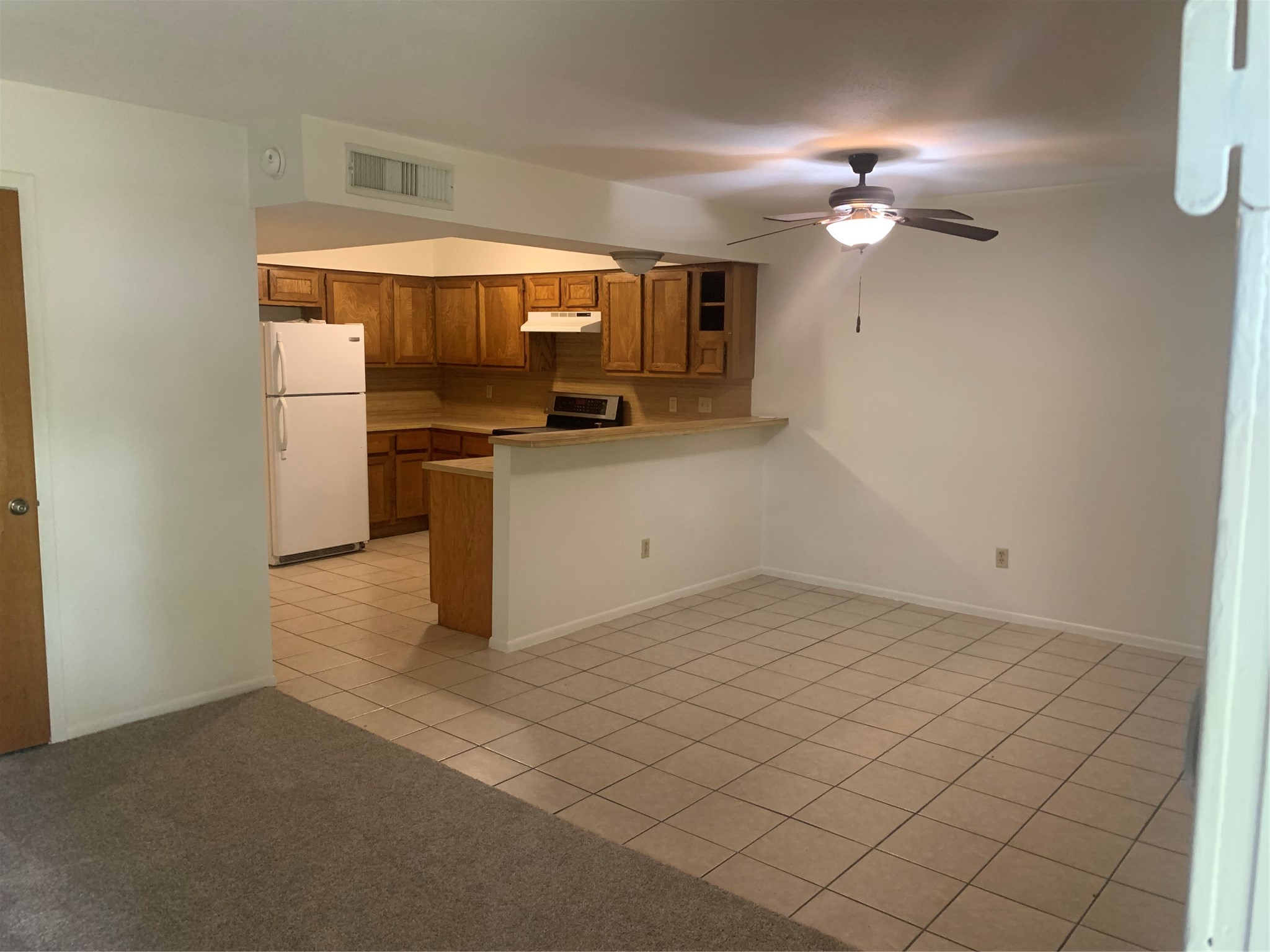 717-719 Cincinnati Street Angleton, TX 77515 - Photo 3 of 8 a kitchen with stainless steel appliances a refrigerator and a stove
