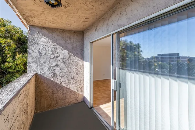 a view of balcony with wooden floor