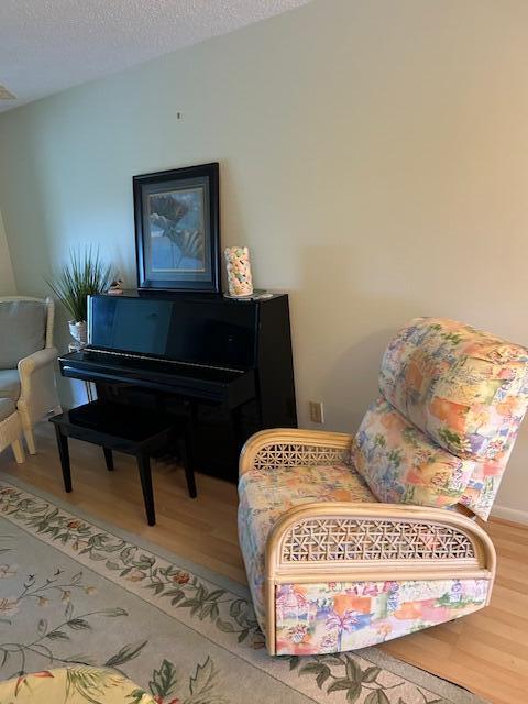 1955 Southwest Palm City Road, Unit H Stuart, FL 34994 - Photo 7 of 22 a bedroom with a bed and a painting on the wall