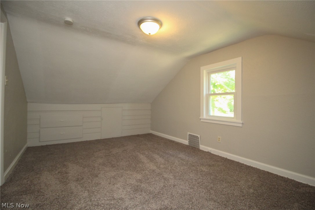 4113 Burgett Road Canfield, OH 44406 - Photo 13 of 31 Additional living space featuring carpet flooring and lofted ceiling